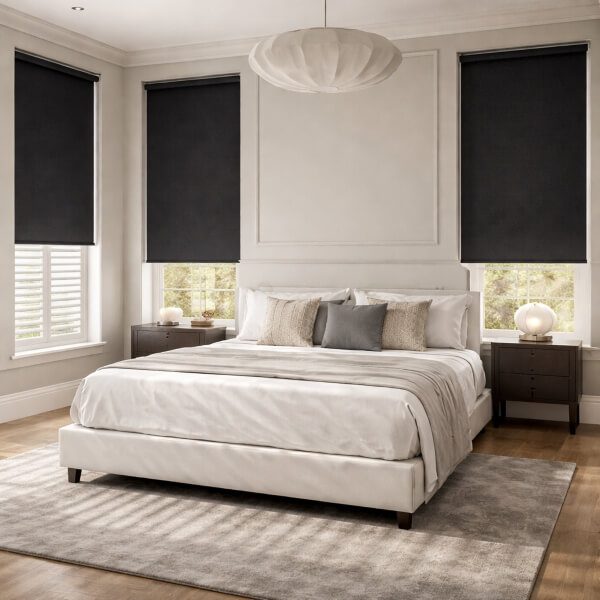 Black blackout roller blinds fitted inside bedroom windows for strong light block and privacy, installed by Plantation Shutters Newcastle.